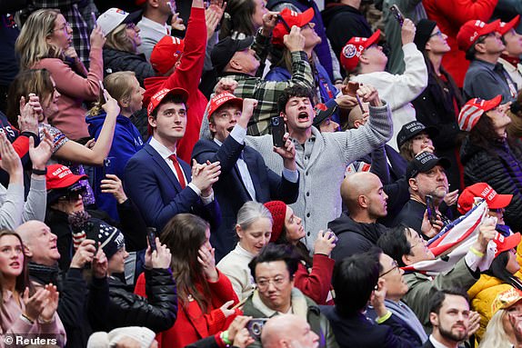 Attendees cheer inside Capital One arena as Donald Trump is sworn in as the U.S President on the inauguration day of his second Presidential term, in Washington, U.S. January 20, 2025. REUTERS/Mike Segar