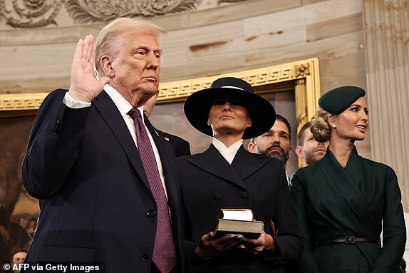 U.S. President-elect Donald Trump takes the oath of office as Melania Trump, Ivanka Trump, Donald Trump Jr. and Eric Trump look on during inauguration ceremonies in the Rotunda of the U.S. Capitol on January 20, 2025 in Washington, DC. Donald Trump takes office for his second term as the 47th president of the United States. (Photo by Chip Somodevilla / AFP) (Photo by CHIP SOMODEVILLA/AFP via Getty Images)