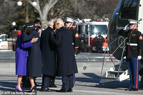 US President Donald Trump and First Lady Melania Trump participate in a departure ceremony for former President Joe Biden and former First Lady Jill Biden, before the Bidens board a helicopter outside the US Capitol in Washington, DC, on January 20, 2025. (Photo by Jim WATSON / AFP) (Photo by JIM WATSON/AFP via Getty Images)