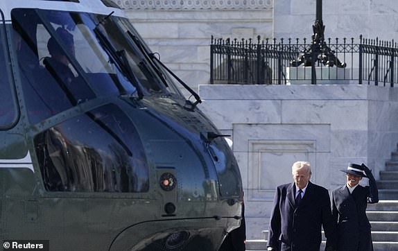 U.S. President Donald Trump and U.S. first lady Melania Trump walk from the U.S. Capitol building as they board Marine One on the inauguration day of Donald Trump's second presidential term in Washington, U.S.  January 20, 2025. REUTERS/Elizabeth Frantz