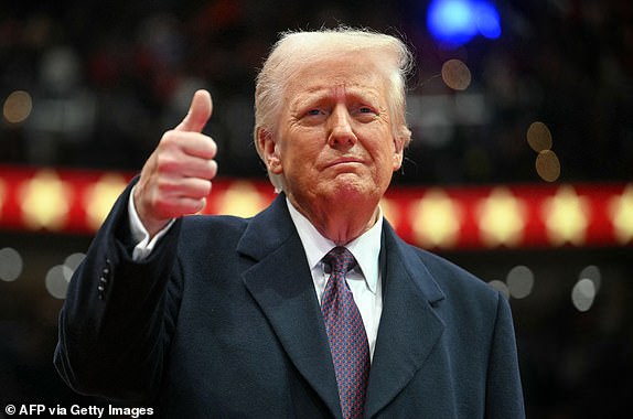 US President Donald Trump gives a thumb's up as he arrives for the inaugural parade inside Capital One Arena, in Washington, DC, on January 20, 2025. (Photo by Jim WATSON / AFP) (Photo by JIM WATSON/AFP via Getty Images)