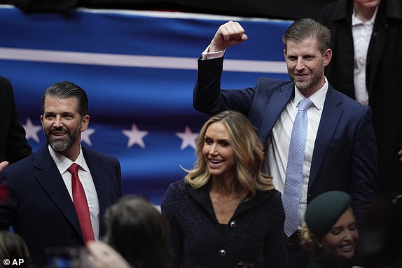 Donald Trump, Jr., Laura Trump and Eric Trump, attend an indoor Presidential Inauguration parade event in Washington, Monday, Jan. 20, 2025. (AP Photo/Susan Walsh)