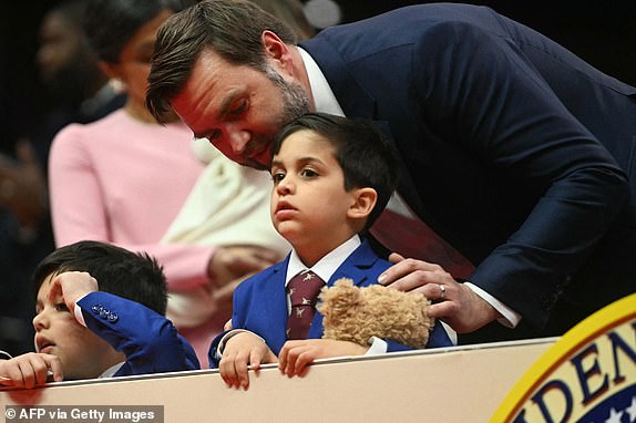 US Vice President J.D. Vance speaks with his sons Ewan and Vivek during the inaugural parade inside Capital One Arena, in Washington, DC, on January 20, 2025. (Photo by Jim WATSON / AFP) (Photo by JIM WATSON/AFP via Getty Images)