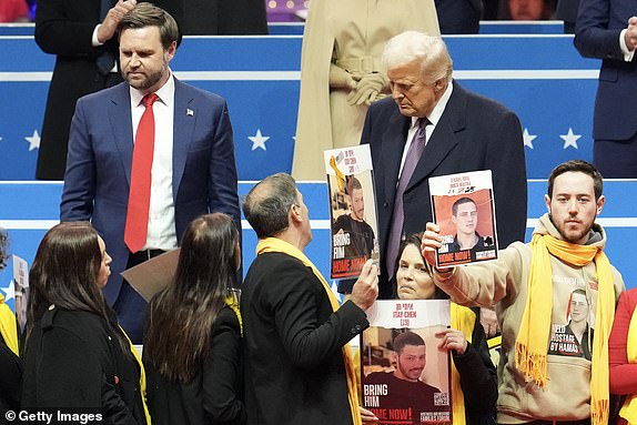 WASHINGTON, DC - JANUARY 20: U.S. Vice President J.D. Vance   and U.S. President Donald Trump meets the families of hostages during an indoor inauguration parade at Capital One Arena on January 20, 2025 in Washington, DC. Donald Trump takes office for his second term as the 47th president of the United States. (Photo by Christopher Furlong/Getty Images)