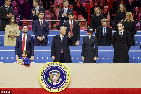 epa11840656 US President Donald Trump (C) with First Lady Melania Trump (2-R), their son Barron Trump (R) and US Vice President JD Vance (L) on stage to watch a truncated presidential inaugural parade and to address supporters gathered for an inauguration eventat the Capitol One Arena in Washington, DC, USA, 20 January 2025. Earlier today Trump was sworn in for a second term as president of the United States in the rotunda of the US Capitol, though the ceremonies and events surrounding the presidential inauguration were moved indoors due to extreme cold temperatures.  EPA/ALLISON DINNER