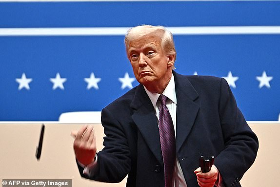 TOPSHOT - US President Donald Trump throws sharpies to the crowd after signing executive orders during the inaugural parade inside Capital One Arena, in Washington, DC, on January 20, 2025. (Photo by ANGELA WEISS / AFP) (Photo by ANGELA WEISS/AFP via Getty Images)