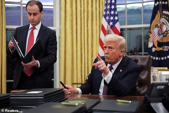 U.S. President Donald Trump gestures on the day he signs pardons for January 6 defendants in the Oval Office at the White House on Inauguration Day in Washington, U.S., January 20, 2025.  REUTERS/Carlos Barria     TPX IMAGES OF THE DAY