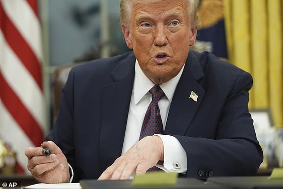 President Donald Trump talks as he signs executive orders in the Oval Office of the White House, Monday, Jan. 20, 2025, in Washington. (AP Photo/Evan Vucci)