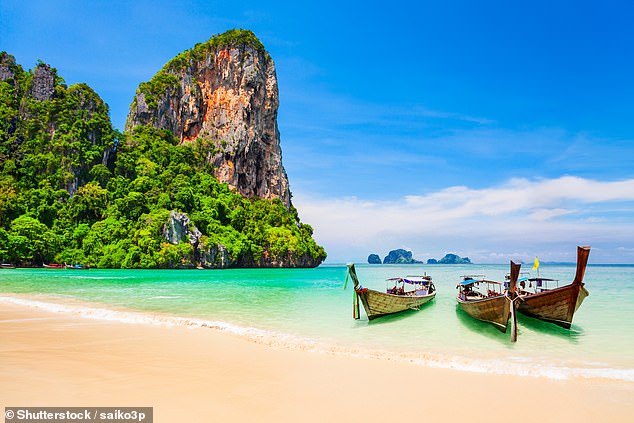 Boats at the beauty beach with limestone cliff and crystal clear water in Koh Samui