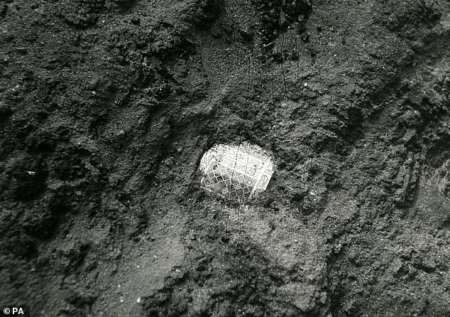 Photo from Trustees of the British Museum showing the discovery of a gold and garnet shoulder clasp from the ship burial mound at Sutton Hoo