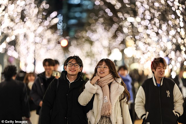 A young couple in Tokyo. Last year, Tokyo's metro government even launched its own dating app to try and boost the birthrate. The move was described by a Tokyo official as a 'gentle push' to help young singles in the capital find their future wives and husbands