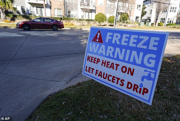 A freeze warning sign stands outside of an apartment complex in North Texas as the area braces for Winter Storm Cora