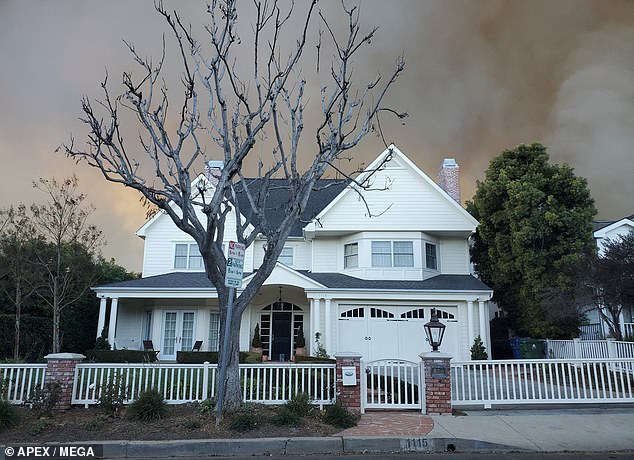 Pictured: The gorgeous home as smoke billowed in the distance behind as the fire approached