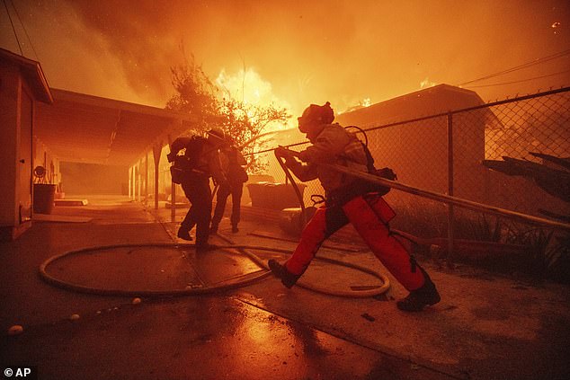 Firefighters protect a structure as the Eaton Fire advances