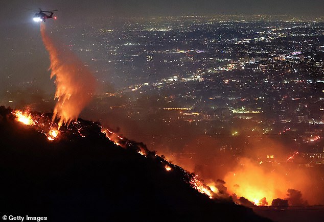 Fire crews are dropping water from the skies in an effort to contain the blaze and stop the spread to nearby neighborhoods