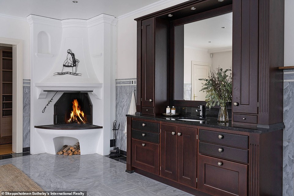 The house is complete with cosy wood-burning fireplaces and classy marble and white details