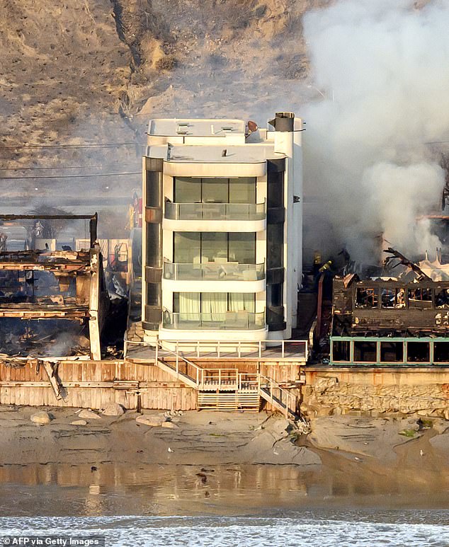 The three-storey home appears almost pristine following thing the fires the devastated everything around it