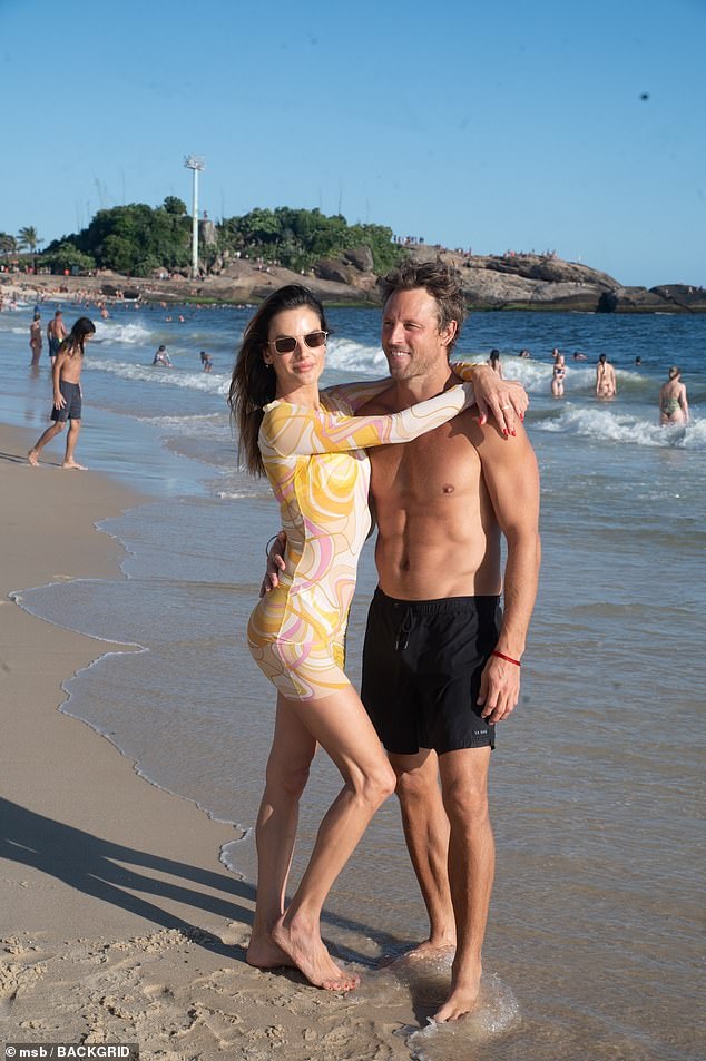 The couple posed for a cute photo op on the beach