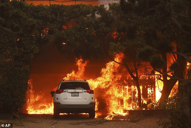 The Palisades Fire burns a structure in the Pacific Palisades neighborhood of Los Angeles, pictured on Wednesday