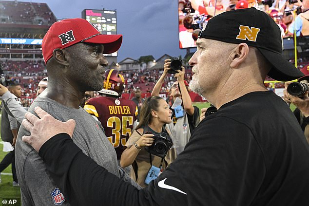 Tampa Bay Buccaneers head coach Todd Bowles, left, and Washington Commanders head coach Dan Quinn greet each other on the field after an NFL football game on September 8