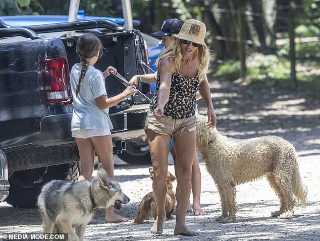 Elsa was seen giving her dogs treated as she rounded up their German Shepherd - who is the latest addition to their clan