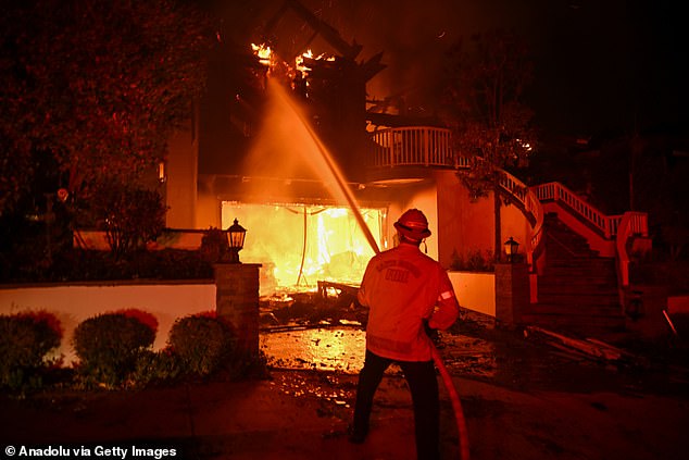 Residents try to escape a burning home in Pacific Palisades, California on January 8, 2025