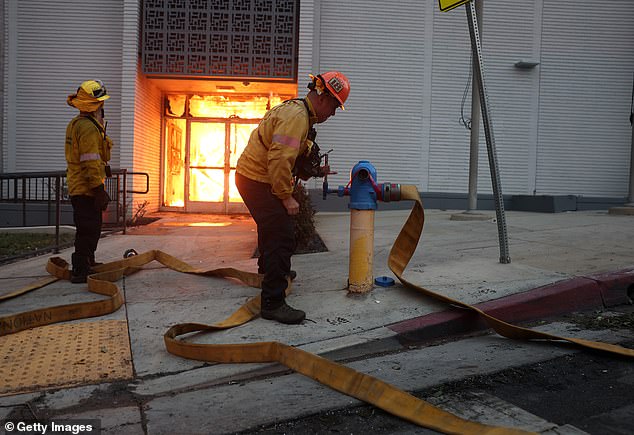 Los Angeles County firefighters try unsuccessfully to get water from a hydrant as they battle the Eaton Fire