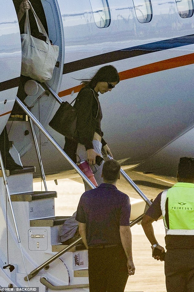 Dressed in a casual hoodie and baseball cap, Leo appeared unfazed as he stepped off the plane alongside Ceretti, 26, who wore an all-black ensemble