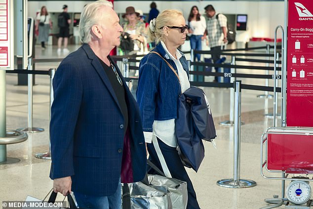 Carrying their baggage through the terminal, the pair went incognito with the 60 Minutes star hiding her eyes behind a pair of dark shades