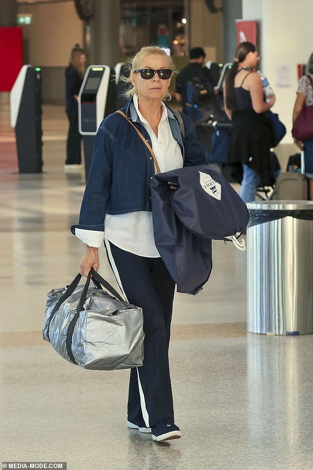 Liz looked very chic in a casual, layered ensemble which featured a cropped blue jean jacket pulled on over a white button-down