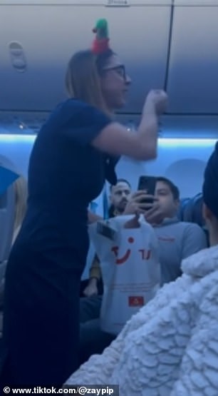 Her fiery outburst, applauded by those around her, was filmed by a passenger who told MailOnline Travel that the group had 'caused chaos' throughout the flight