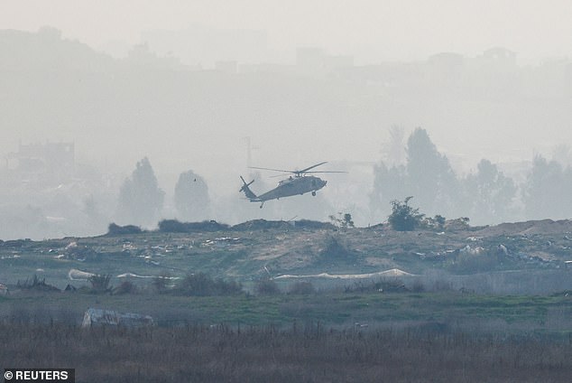 An Israeli Black Hawk military helicopter lands inside North Gaza, amid the ongoing conflict between Israel and Hamas on January 14