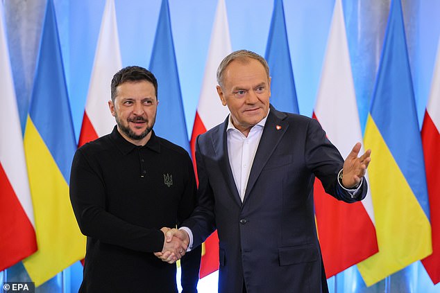 Polish Prime Minister Donald Tusk (R) welcomes Ukrainian President Volodymyr Zelensky (L) ahead of their talks in Warsaw