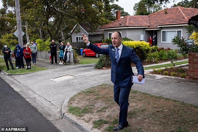 House prices across the capital cities grew at 1.1 per cent over the last three months of 2024, slower than the average of recent years (pictured, an auction in Melbourne)