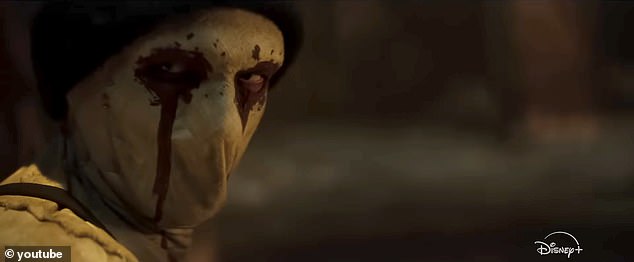 Near the end of the jam-packed teaser trailer, a new masked face is seen