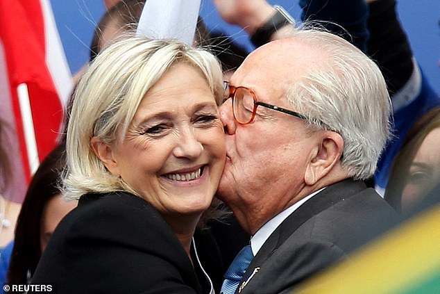 Jean-Marie Le Pen, France's National Front political party founder, embraces his daughter Marine Le Pen in 2013