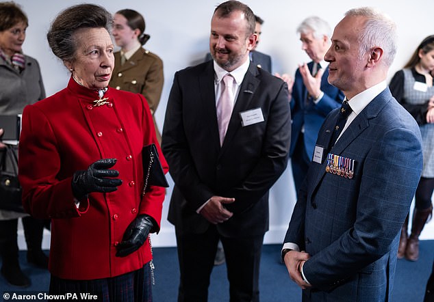 The royal sported a red jacket for the outing, which she paired with a dark skirt, black gloves, and a black handbag