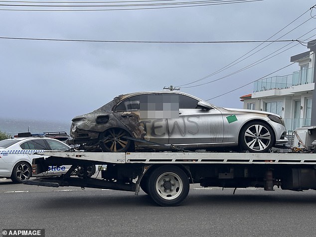 Multiple cars parked on Military Road in Dover Heights were spray painted with anti-Semitic slogans and two were set alight set alight around 4am (pictured)