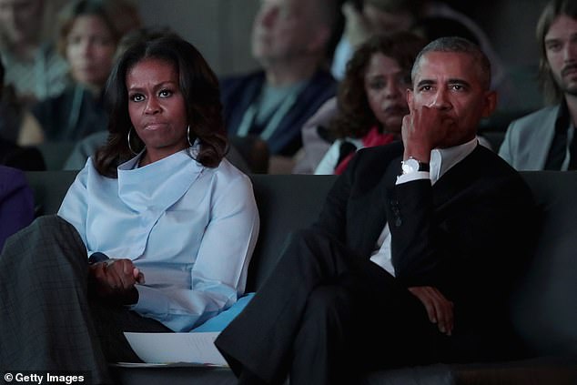 Michelle and Barack Obama listen to speakers at the inaugural Obama Foundation Summit on October 31, 2017