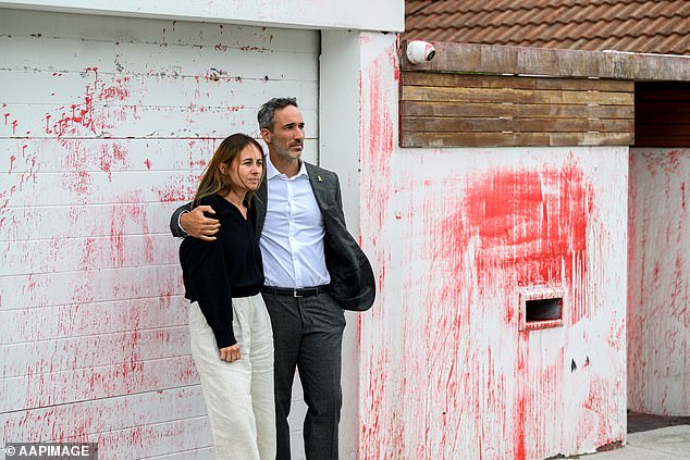 Mr Ryvchin said the attack 'meets a modern standard of terrorism' (pictured with his wife outside their former family home)