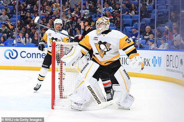 Nedeljkovic watches as a puck he shot trickles down the ice towards an empty net on Friday