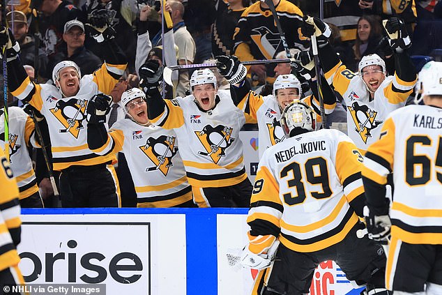 Nedeljkovic (39) skates over to his bench to celebrate scoring the goal with his teammates