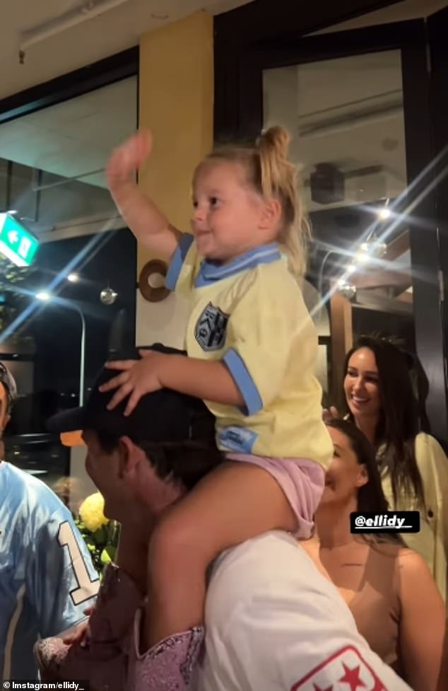 The podcaster was celebrating her latest collaboration with fashion label Ena Pelly on the Gold Coast when she stepped out with the joyful toddler (pictured)