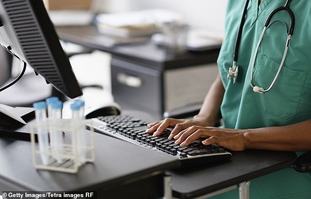 A nurse working at a computer (stock image). Record numbers of patients are paying for private cancer treatment and heart surgery rather than risking waiting for NHS care