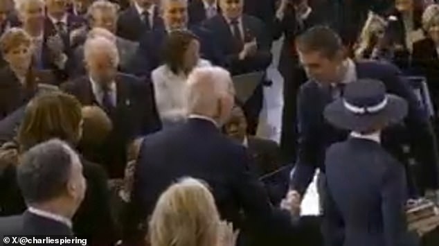 Barron Trump (right) was hailed 'a true gentleman' for shaking hands with Joe Biden and Kamala Harris