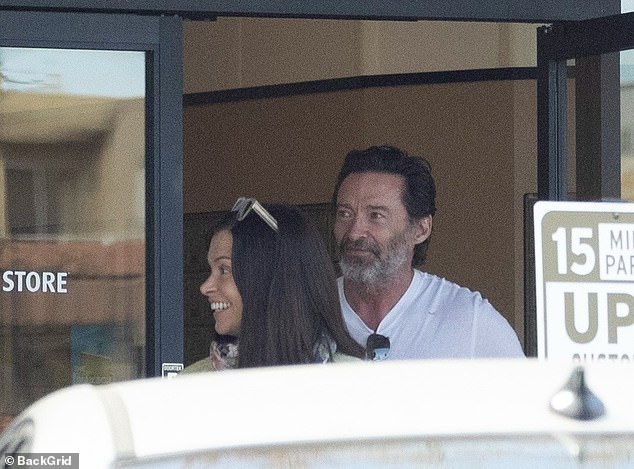 Hugh looked fit as a fiddle as he flaunted his muscular physique in stylish casualwear, consisting of a plain white T-shirt, black pants and sunglasses