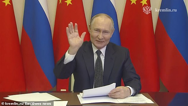 Putin is seen waving as he greets Chinese President Xi Jinping during a video call