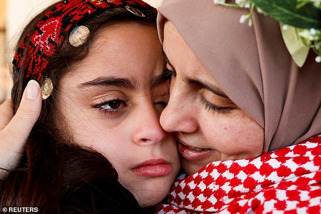 Freed Palestinian prisoner Nidaa Zaghebi embraces her daughter, Cilla, after her release from an Israeli jail as part of a hostages-prisoners swap on Sunday