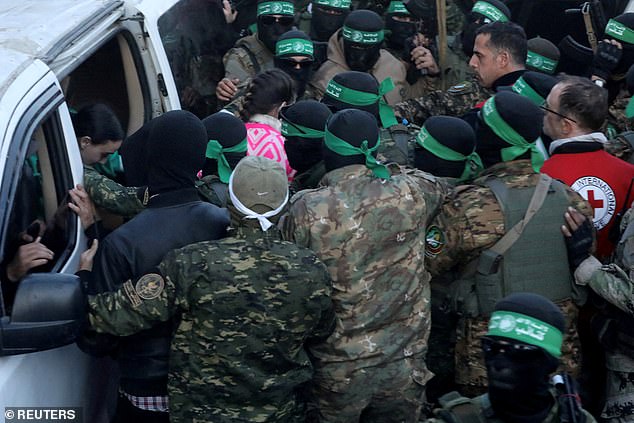 Hamas fighters hand over Emily Damari and Doron Steinbrecher, hostages kidnapped during the October 7 attack on Israel by Hamas, to members of the International Committee of the Red Cross (ICRC)