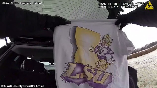 Footage cuts to a trooper searching the vehicle and he pulls an LSU shirt out of a white bin liner